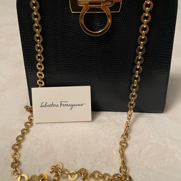 Authentic Salvatore Ferragamo black leather bag with shiny gold metal handle. - Picture 4 of 11